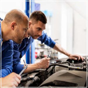 mechanics inspecting vehicle 